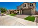 Two-story house with a two-car garage and landscaped yard at 24077 N 160Th Ave, Surprise, AZ 85387