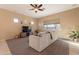 Spacious living room with gray sectional sofa and large window at 27204 N 86Th Dr, Peoria, AZ 85383