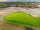 Golf course community with houses, palm trees, and mountains in background at 3533 N 159Th Ln, Goodyear, AZ 85395