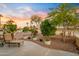Landscaped backyard with lounge chair, potted plants, and golf course view at 3533 N 159Th Ln, Goodyear, AZ 85395
