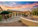 Spacious backyard patio with seating area, water feature, and solar panels at 3533 N 159Th Ln, Goodyear, AZ 85395