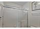 Clean bathroom with white tile, shower, and a window for natural light at 3533 N 159Th Ln, Goodyear, AZ 85395