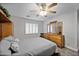 Guest bedroom with wood dresser and ceiling fan at 3533 N 159Th Ln, Goodyear, AZ 85395