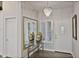 Elegant entryway with mirror, console table, and chandelier at 3533 N 159Th Ln, Goodyear, AZ 85395