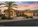 Tan two-story house with tile roof, arched entry, and landscaped yard at 3533 N 159Th Ln, Goodyear, AZ 85395