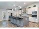 Gourmet kitchen with large island, granite countertops, and stainless steel appliances at 3533 N 159Th Ln, Goodyear, AZ 85395
