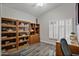 Home office featuring built-in bookshelves and window shutters at 3533 N 159Th Ln, Goodyear, AZ 85395