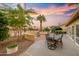 Backyard patio with seating, fountain, and sliding glass doors to interior at 3533 N 159Th Ln, Goodyear, AZ 85395