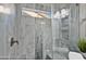 Walk-in shower with gray tile and built-in shelving at 3533 N 159Th Ln, Goodyear, AZ 85395