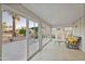 Bright sunroom with tiled floor, glass walls, and comfy seating at 3533 N 159Th Ln, Goodyear, AZ 85395
