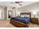 Main bedroom with a dark wood platform bed and ceiling fan at 39517 N Gold Mine Ln, Phoenix, AZ 85086