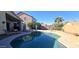 Sparkling kidney-shaped pool with patio furniture and a covered patio at 41550 W Cheyenne Ct, Maricopa, AZ 85138