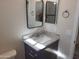 Bathroom vanity with granite countertop and a rectangular mirror at 48111 N 7Th Ave, New River, AZ 85087