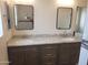 Double vanity bathroom with granite countertop and mirrors at 48111 N 7Th Ave, New River, AZ 85087