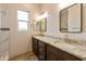 Double vanity bathroom with granite countertops and tile shower at 48111 N 7Th Ave, New River, AZ 85087
