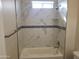 Bathroom with marble tile shower and bathtub at 48111 N 7Th Ave, New River, AZ 85087