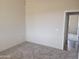 Spacious bedroom with neutral walls, carpet flooring, and a view into another room at 48111 N 7Th Ave, New River, AZ 85087