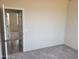 Bedroom with neutral walls and carpet flooring, showing a view into another room at 48111 N 7Th Ave, New River, AZ 85087