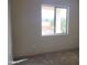 Bedroom with a window showcasing a scenic view, carpeted floors, and neutral walls at 48111 N 7Th Ave, New River, AZ 85087