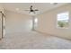 Bright bedroom featuring carpet, ceiling fan, and barn door at 48111 N 7Th Ave, New River, AZ 85087