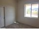 Bright bedroom with a window offering an exterior view and carpeted floors at 48111 N 7Th Ave, New River, AZ 85087