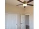 Bedroom featuring a ceiling fan, double sliding doors, and a door to another room at 48111 N 7Th Ave, New River, AZ 85087