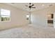 Spacious bedroom with carpeted floor and ceiling fan at 48111 N 7Th Ave, New River, AZ 85087