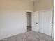 Spacious bedroom with neutral walls, carpet flooring, and doors to other rooms at 48111 N 7Th Ave, New River, AZ 85087