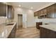 Modern kitchen with dark wood cabinets and granite countertops at 48111 N 7Th Ave, New River, AZ 85087