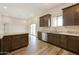 Modern kitchen with dark brown cabinetry and granite countertops at 48111 N 7Th Ave, New River, AZ 85087