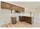 Modern kitchen with dark brown cabinetry and granite countertops at 48111 N 7Th Ave, New River, AZ 85087