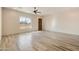 Spacious living room with wood-look tile flooring and ceiling fan at 48111 N 7Th Ave, New River, AZ 85087