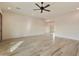 Spacious living room with wood-look tile flooring and ceiling fan at 48111 N 7Th Ave, New River, AZ 85087