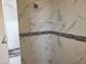 Shower with marble-style tile and built-in seat at 48111 N 7Th Ave, New River, AZ 85087