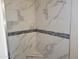 Large shower with marble-look tile and mosaic accents at 48111 N 7Th Ave, New River, AZ 85087