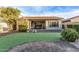 Artificial turf backyard with a view of the house and patio at 5230 W El Cortez Trl, Phoenix, AZ 85083