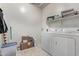 Convenient laundry room with washer, dryer, and shelving at 5230 W El Cortez Trl, Phoenix, AZ 85083