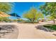 Landscaped pool area with shade structures and lounge chairs at 5451 W Victory Way, Florence, AZ 85132