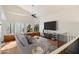 Living room with hardwood floors, a ceiling fan, and a large TV at 5525 W Harrison Ct, Chandler, AZ 85226