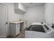 Bright laundry room with modern washer, dryer, and built-in cabinetry at 5637 N 8Th Dr, Phoenix, AZ 85013