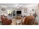 Spacious living room featuring leather furniture and a view to the backyard at 6144 E Minton Pl, Mesa, AZ 85215