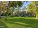 Expansive backyard with a lush lawn, mature trees, and a glimpse of the pool at 6240 N 59Th Pl, Paradise Valley, AZ 85253