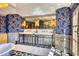 Bathroom with double vanity, patterned floors, and blue wallpaper at 6240 N 59Th Pl, Paradise Valley, AZ 85253