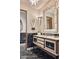 Elegant bathroom with black marble flooring and a unique cream vanity at 6240 N 59Th Pl, Paradise Valley, AZ 85253