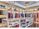 Organized closet with clothing, hats, and a marble center island at 6240 N 59Th Pl, Paradise Valley, AZ 85253