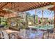 Outdoor dining area with a large table under a pergola at 6240 N 59Th Pl, Paradise Valley, AZ 85253