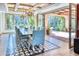 Sunlit dining room features a long wooden table and access to a private patio at 6240 N 59Th Pl, Paradise Valley, AZ 85253