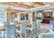 Elegant dining room with a large table, blue chairs, and access to the backyard at 6240 N 59Th Pl, Paradise Valley, AZ 85253