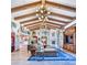 Spacious living room with high ceilings, exposed beams, and a large chandelier at 6240 N 59Th Pl, Paradise Valley, AZ 85253