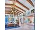 Open living room with high ceilings, exposed beams, and access to outdoor patio at 6240 N 59Th Pl, Paradise Valley, AZ 85253